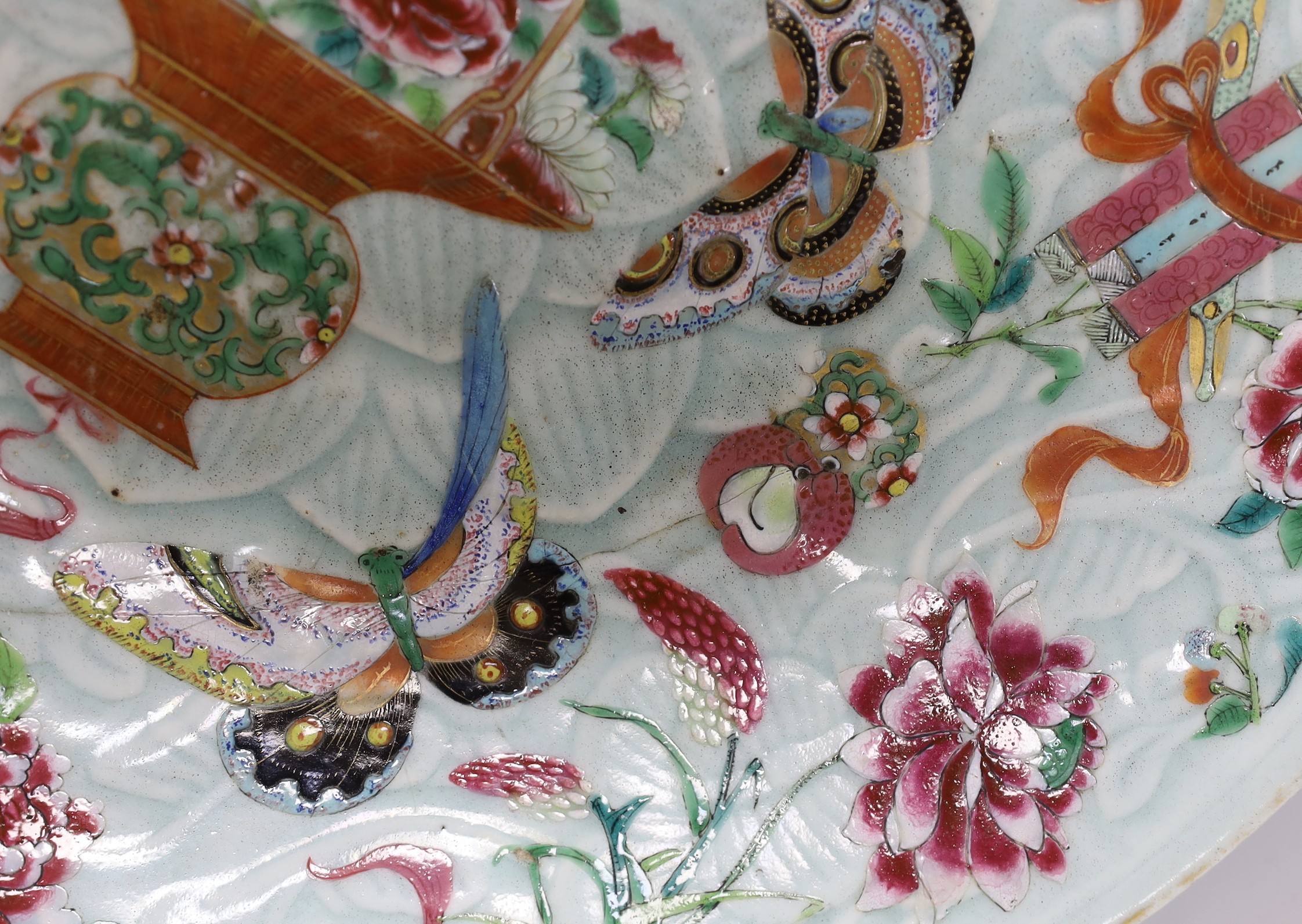A 19th century Chinese famille rose enamelled carved celadon glazed dish, 34cm